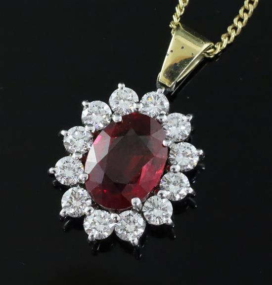 An 18ct gold and platinum ruby and diamond cluster pendant on 18ct gold fine chain, pendant 12mm.